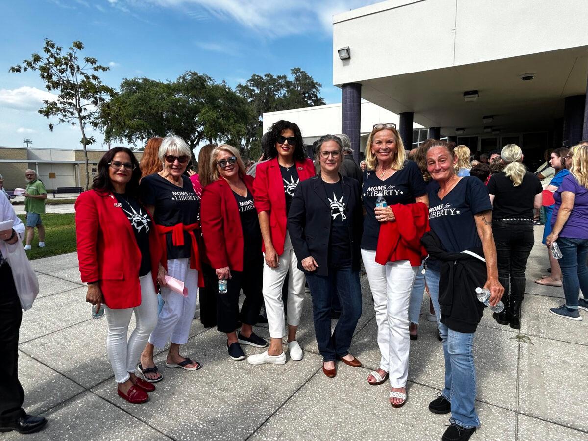Mary Mazzuco of Weeki Wachi (left) stands with her fellow Moms for Liberty members while waiting to attend the Hernando County School Board meeting in Brooksville, Fla., on May 30, 2023. (Patricia Tolson/The Epoch Times)
