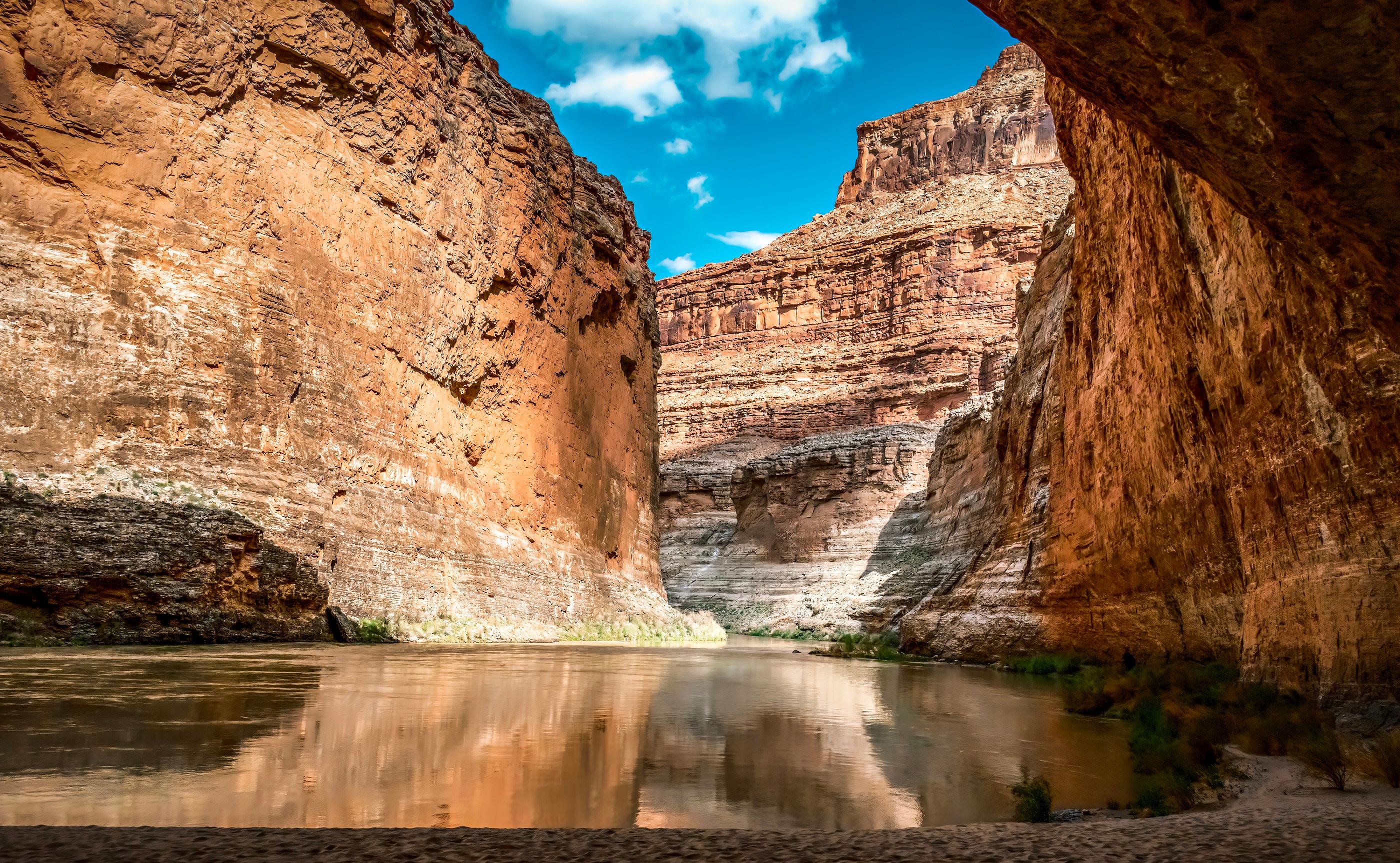 Canyon walls reflected in glassy water. (Maria Coulson)