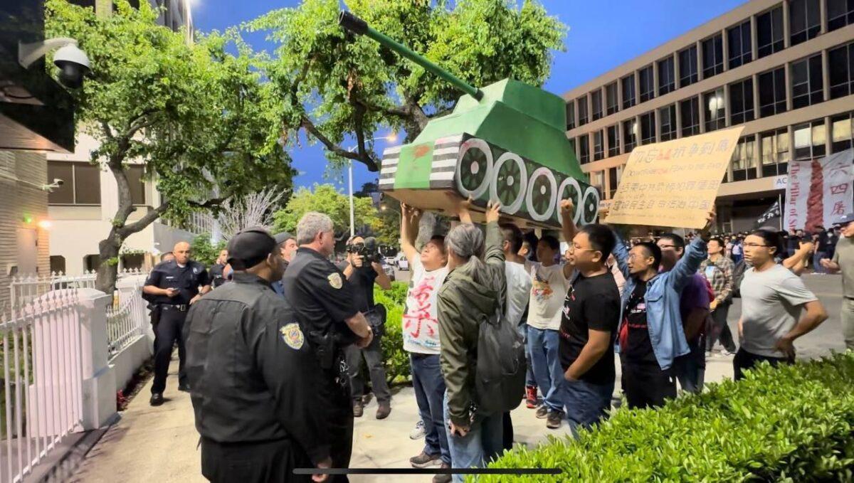 In front of the Chinese Consulate in Los Angeles, people raise a model tank symbolizing the massacre of civilians during the Tiananmen Square Massacre that happened in Beijing, June 4, 1989. (Courtesy of Jie Lijian)