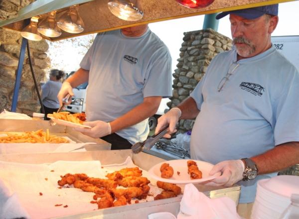 Staff serving fish and chips at the Lions Fish Fry and Carnival in Costa Mesa, Calif. (Courtesy of the Lions Club)