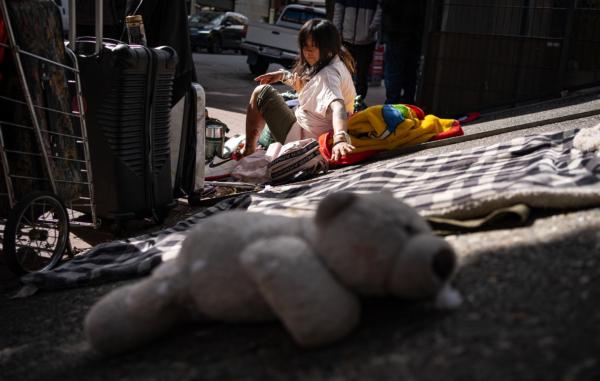 A homeless woman and her belongings in San Francisco, Calif., on Feb. 23, 2023. (John Fredricks/The Epoch Times)