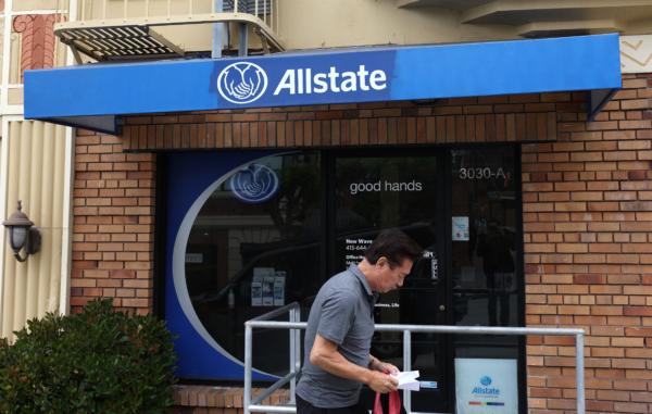 A pedestrian walks by an Allstate Insurance office in San Francisco on June 9, 2023. (Justin Sullivan/Getty Images)