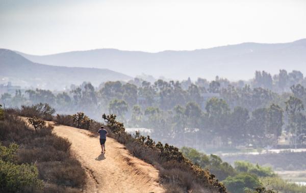 A runner jogs around the back bay of Newport Beach District 3 in Newport Beach, Calif., on Sept. 8, 2022. (John Fredricks/The Epoch Times)