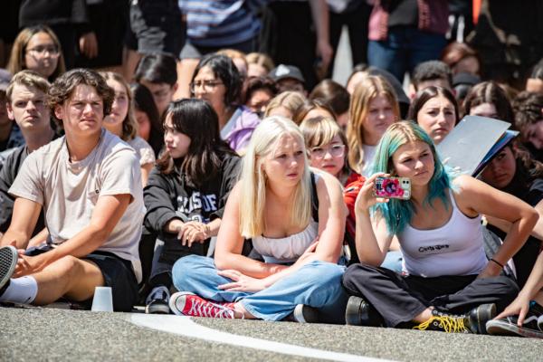 High school students watch a mock DUI situation constructed by local law enforcement and first responders' agencies in Orange County, Calif., on April 25, 2022. (John Fredricks/The Epoch Times)