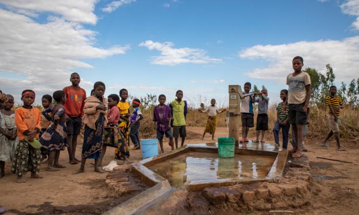 Villagers use their new well built by Water Wells for Africa in Khobwe Village 2, Malawi, on July 6, 2021. (John Fredricks/The Epoch Times)