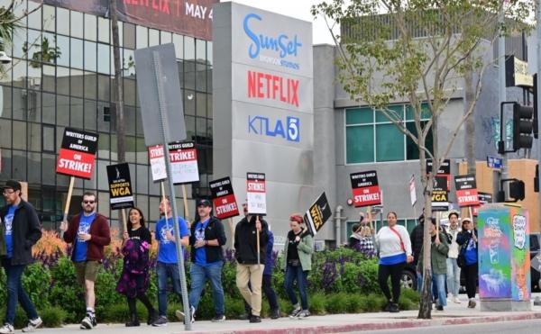 Writers on the picket line on the fourth day of the strike by the Writers Guild of America march past Netflix in Hollywood, Calif., on May 5, 2023. (Frederic J. Brown/AFP via Getty Images)