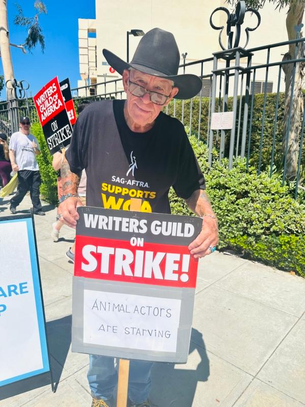 Longtime member of the entertainment industry Greg Twiford, president of TV & Motion Pictures Animal Trainers Association, demonstrated in support of the Screen Actors Guild-American Federation of Television and Radio Artists (SAG-AFTRA) outside Disney Studios in Burbank, Calif., on July 18, 2023. Twiford, also a member of Teamsters Local 399, said he was trying to end the strike because the animal actors were starving. (Jill McLaughlin/The Epoch Times)