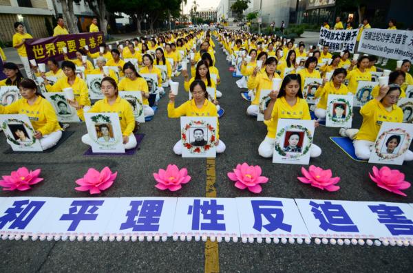 Falun Gong adherents hold a candlelight vigil in front of the Chinese Consulate to mark 24 years of persecution by the Chinese Communist Party in Los Angeles on July 18, 2023. (Alex Lee/The Epoch Times)