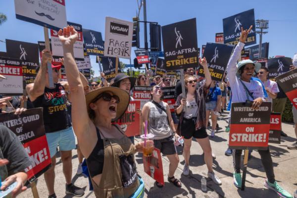 Members of the Hollywood actors SAG-AFTRA union walk a picket line with screenwriters outside of Paramount Studios on Day 2 of the actors' strike in Los Angeles, Calif., on July 14, 2023. (David McNew/Getty Images)