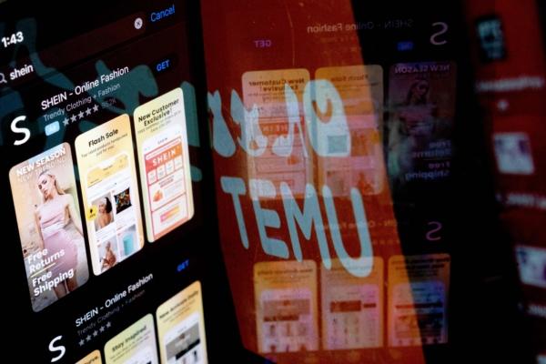 The Shein app on the app store reflected in the Temu logo, in Washington on Feb. 23, 2023. (Stefani Reynolds/AFP via Getty Images)