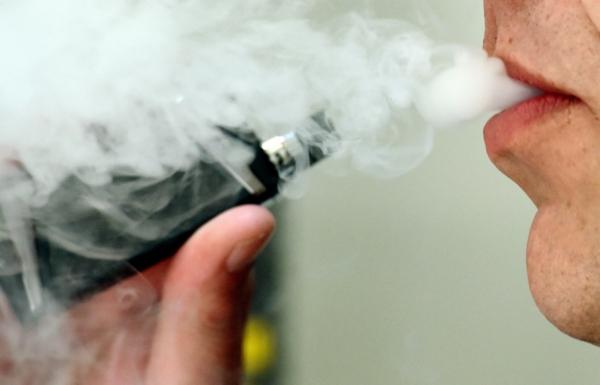 A man exhaling whilst using a vaping product on Feb. 21, 2020. California law prohibits the sale of e-cigarettes and vape products to anyone under 21. (PA Media)