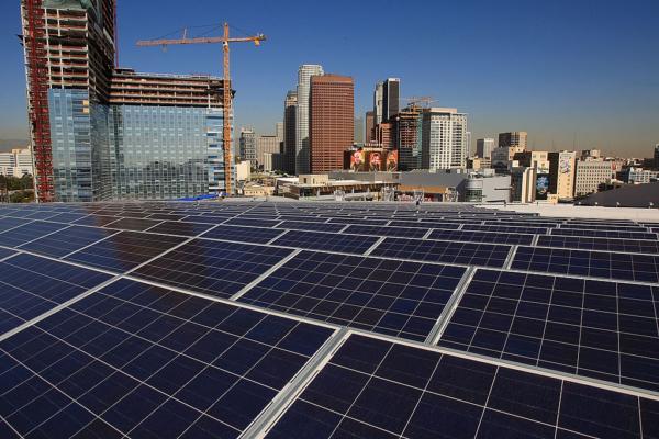 The L.A. Live construction project at left rises in the distance as 1,727 solar panels cover the rooftop of the then-Staples Center sports complex, now known as Crypto.com Arena, in Los Angeles on Oct. 28, 2008. (David McNew/Getty Images)