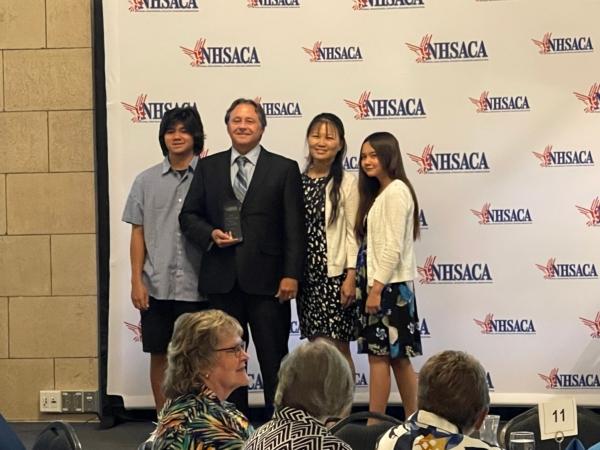 Jeff Gordon (2nd L), retired girls’ soccer coach at Fullerton’s Sunny Hills High School, is accompanied by his wife, son, and daughter at the National High School Athletic Coaches Association Hall of Fame ceremony at the Historic Haymarket in Lincoln, Neb., on July 25, 2023. (Courtesy of Jeff Gordon)