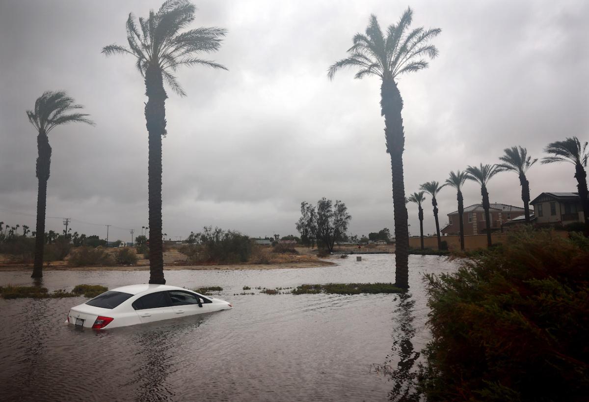 A car is partially submerged in floodwaters as Tropical Storm Hilary moves through the area in Cathedral City, Calif., on Aug. 20, 2023. (Mario Tama/Getty Images)