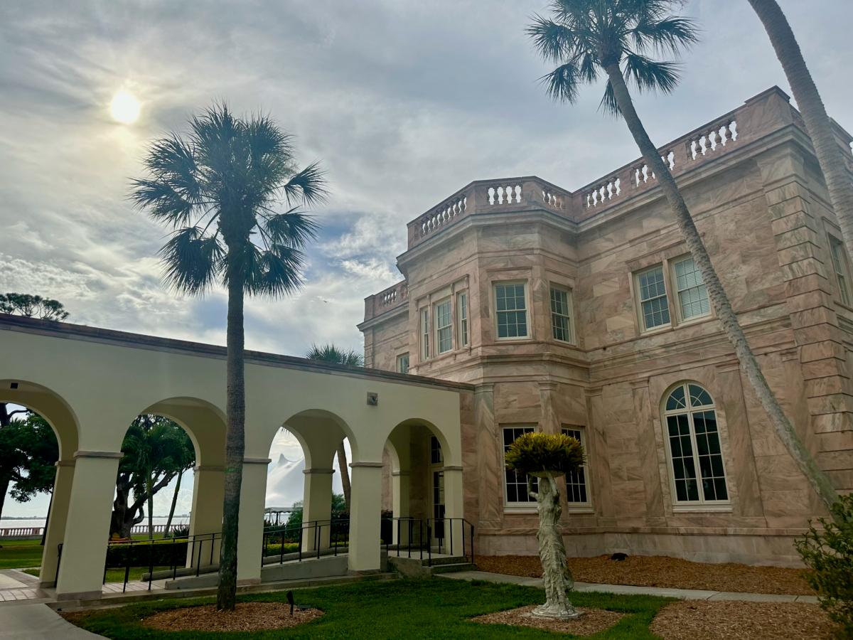 The sun dips and storm clouds gather over Sarasota Bay just west of buildings on the campus of New College of Florida in Sarasota on Aug. 18, 2023. (Nanette Holt/The Epoch Times)