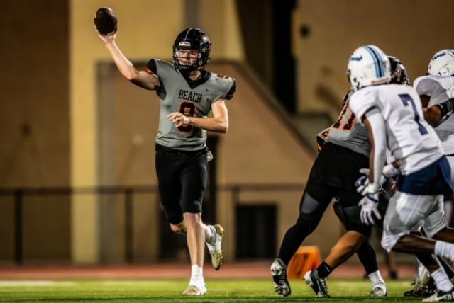 High school football player Brady Edmunds (8) pitches the ball at Huntington Beach’s 34–21 victory over Mayfair in Huntington Beach, Calif., on Aug. 18, 2023. (Jeremy Westerbeck/JPWest Media)