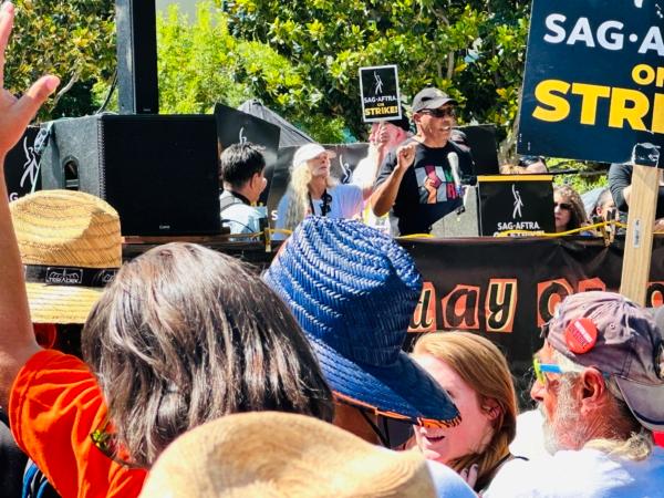 Paris Barclay, secretary-treasurer of the Directors Guild of America, speaks to a large crowd of Hollywood writers and actors at a “National Day of Solidarity” rally that drew an estimated 2,000 union members outside of Disney Studios in Burbank, Calif., on Aug. 22, 2023. (Jill McLaughlin/The Epoch Times)