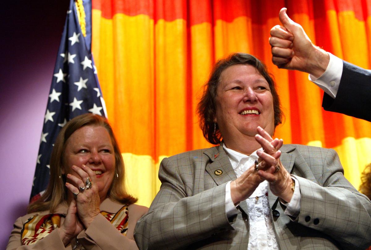 Then California State Assembly Member Jackie Goldberg (C) and her partner, Sharon Stricker (L), stand onstage as they get the thumbs-up from U.S. Assemblyman Mark Leno (R) prior to California Governor Gray Davis signing a law authored by Goldberg which granted benefits to same-sex domestic partners, in San Francisco on Sept. 19, 2003. (Justin Sullivan/Getty Images)