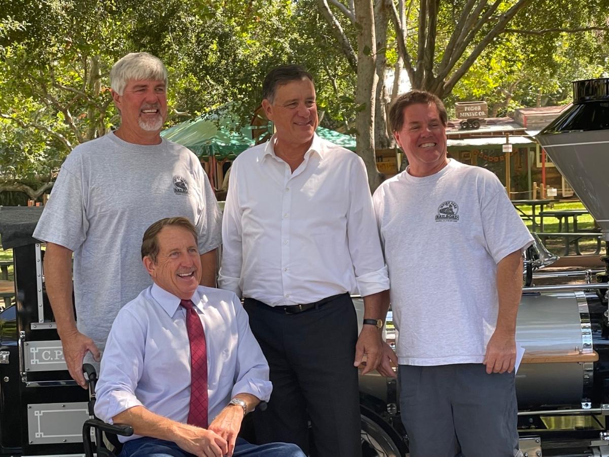 Irvine park railroad co-founders John Ford and Steve Horn pose with OC Supervisor Don Wagner at Irvine Park Railroad electric train opening in Orange, Calif., on Sept. 7, 2023. (Carol Cassis/The Epoch Times)