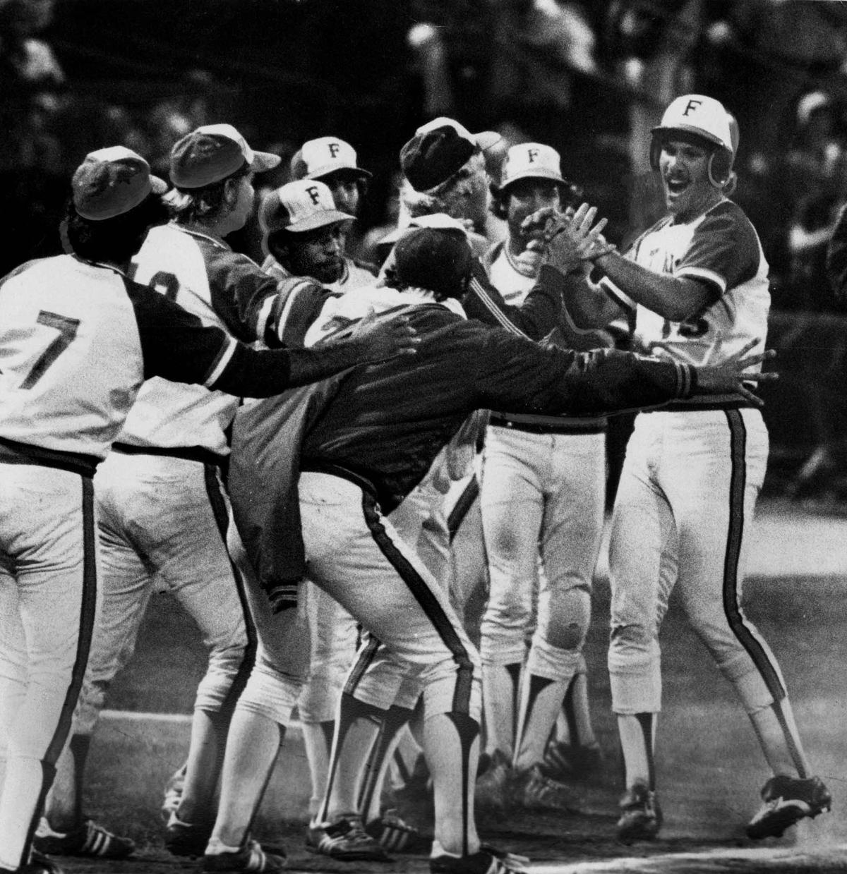 Cal State Fullerton teammates celebrate with Dan Hanggie (R) after his grand slam home run. (Courtesy of Cal State Fullerton)