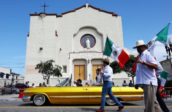 Participants in a lowrider pass a church during the 77th annual East LA Mexican Independence Day Parade in Los Angeles on Sept. 10, 2023. (Mario Tama/Getty Images)