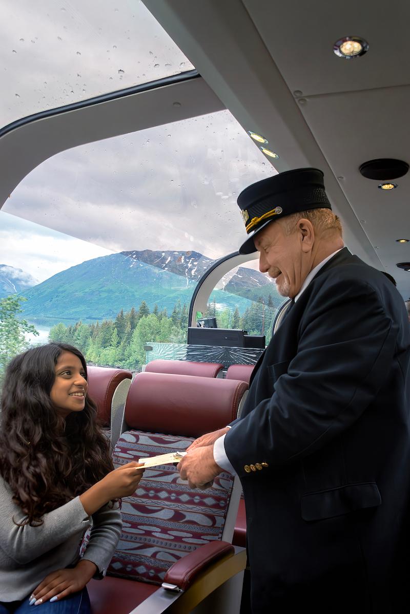 Coastal Classic conductor Warren Redfearn takes ticket from 12-year-old Ramiya Sivapala of Massachusetts. (Maria Coulson)