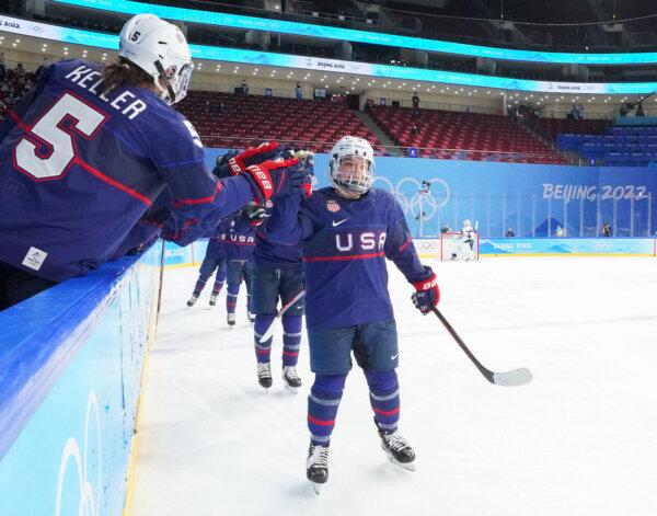 USA's Cayla Barnes (3) celebrates at the bench with Megan Keller (5) after scoring a second period goal against Finland during Women’s Semifinal Round action at the Beijing 2022 Olympic Winter Games at Wukesong Sports Centre in Beijing, China, on Feb. 14, 2022. (Andre Ringuette/HHOF-IIHF Images)