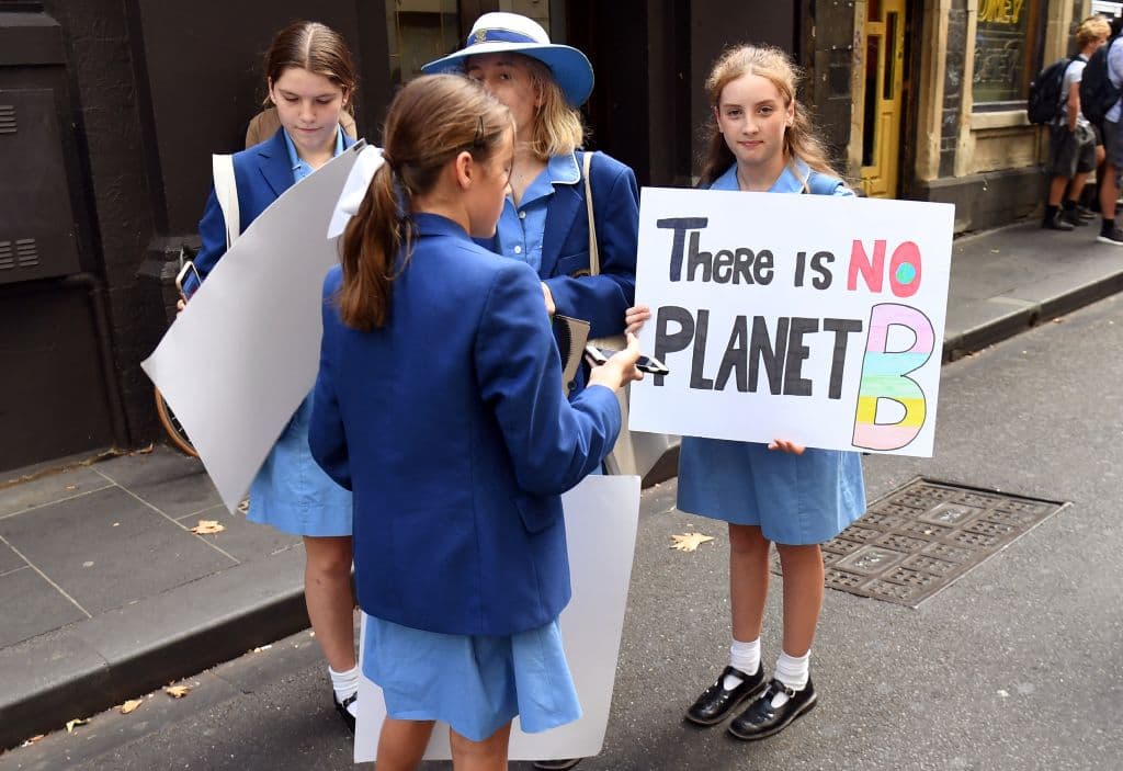 Schoolchildren carry placards to take part in a climate protest in Melbourne, Australia, on May 3, 2019. (William West/AFP via Getty Images)