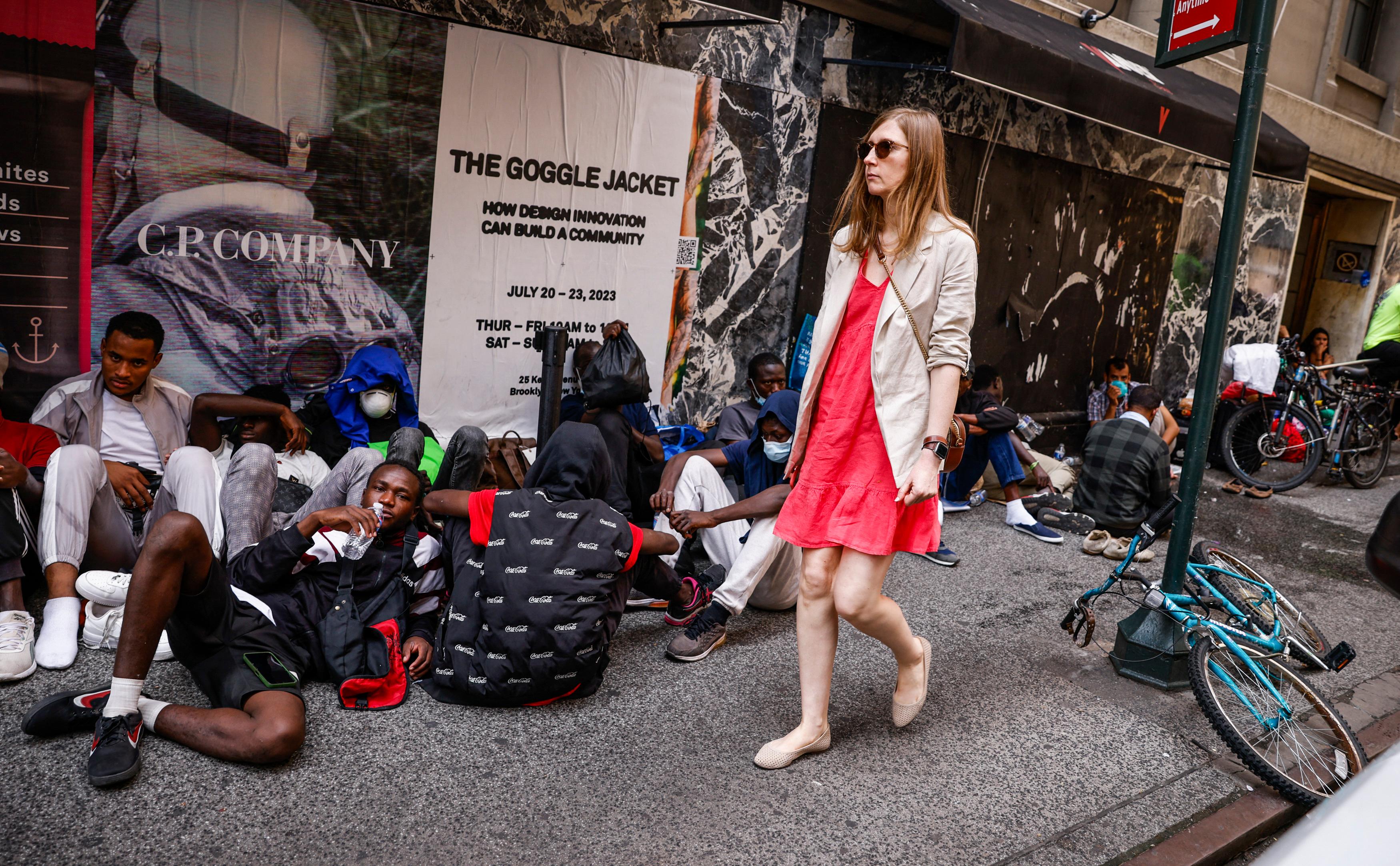 Illegal immigrants wait outside the Roosevelt Hotel in New York City, on July 31, 2023. (Kena Betancur/AFP via Getty Images)