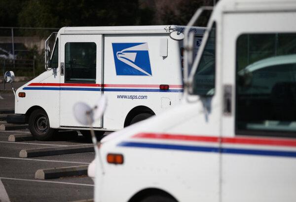 U.S. Postal Service vehicles sit in a parking lot at a mail distribution center on Feb. 18, 2015, in San Francisco. The Postal Service has reported an uptick in mail carrier robberies since the pandemic. (Justin Sullivan/Getty Images)