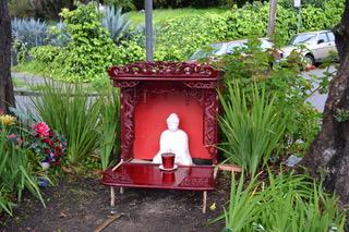 The original Buddha statue painted white with its first wooden temple. (Courtesy of Dan Stevenson)