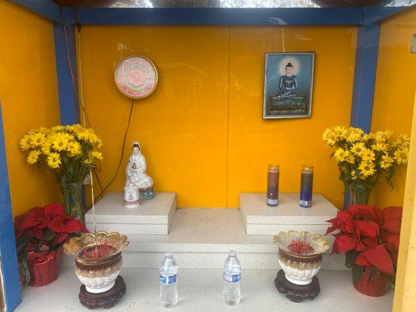 A Guan Yin statue with flowers, incense, candles, and water offerings on Dec. 5, 2023. (Helen Billings/The Epoch Times)