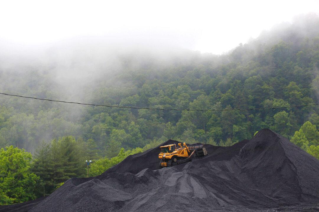 A bulldozer operates atop a coal mound at the CCI Energy Slones Branch Terminal in Shelbiana, Ky, on June 3, 2014. (Luke Sharrett/Getty Images)