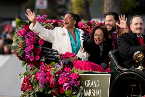 Grand Marshal Audra McDonald, left, waves to the crowd at the 135th Rose Parade in Pasadena, Calif., on Jan. 1, 2024. (Jae C. Hong/AP Photo)