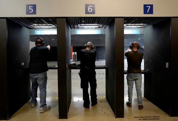 Gun owners fire their pistols at an indoor shooting range during a qualification course to renew their carry concealed handgun permits at the Placer Sporting Club in Roseville, Calif., on July 1, 2022. (Rich Pedroncelli/AP Photo)