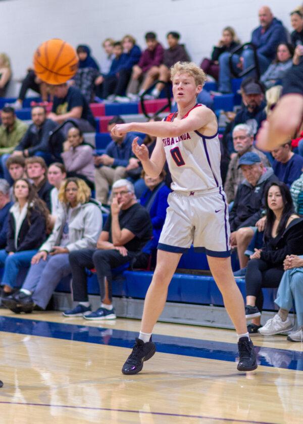 Yorba Linda High School basketball player Kobe Pietsch (0) passes the ball at a recent game. (Courtesy of Phil Mangiaracina