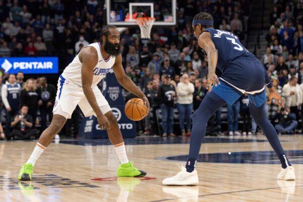 Los Angeles Clippers guard James Harden dribbles while Minnesota Timberwolves forward Jaden McDaniels (3) defends during the first half of an NBA basketball game in Minneapolis on Jan. 14, 2024. (Bailey Hillesheim/AP Photo)