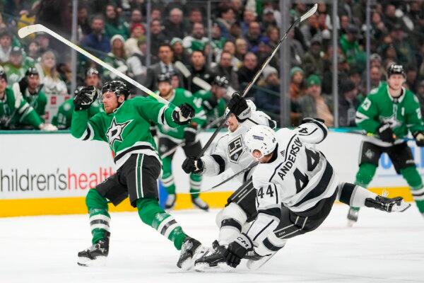 Dallas Stars center Joe Pavelski (L) passes the puck as Los Angeles Kings left wing Kevin Fiala (C) and defenseman Mikey Anderson (44) collide during the first period of an NHL hockey game in Dallas on Jan. 16, 2024. (Julio Cortez/AP Photo)