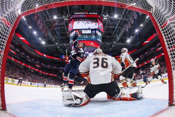 Goalie John Gibson (36) of the Anaheim Ducks tends the net as T.J. Oshie (77) of the Washington Capitals pulls down the puck with his hand during the second period in Washington, D.C., on Jan. 16, 2024. (Patrick Smith/Getty Images)