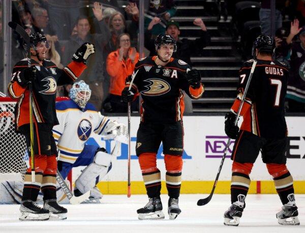 Jakob Silfverberg (33) of the Anaheim Ducks celebrates his goal with Isac Lundestrom (21) and Radko Gudas (7), in front of Ukko-Pekka Luukkonen (1) of the Buffalo Sabres during the first period in Anaheim, Calif., on January 23, 2024. (Harry How/Getty Images)
