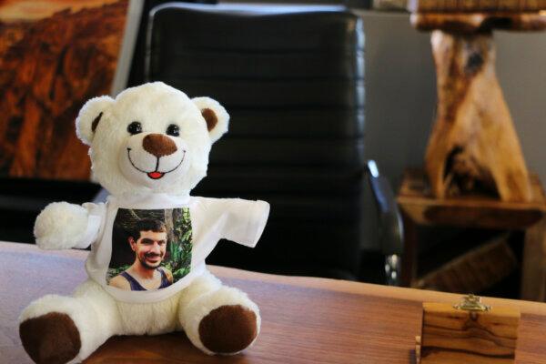 The teddy bear belonging to Almog Levy, a 2-year-old Israeli boy whose father, Or Levy (pictured), has been held hostage by the terrorist group Hamas following a surprise attack on the country on Oct. 7, 2023. Or Levy's older brother, Michael Levy, has traveled around the world with the teddy bear, rallying support to free his brother. (Andrew Chen/The Epoch Times)