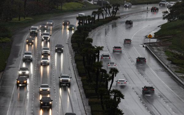 Cars drive through heavy rain in Newport Beach, Calif., on Feb. 5, 2024. (John Fredricks/The Epoch Times)