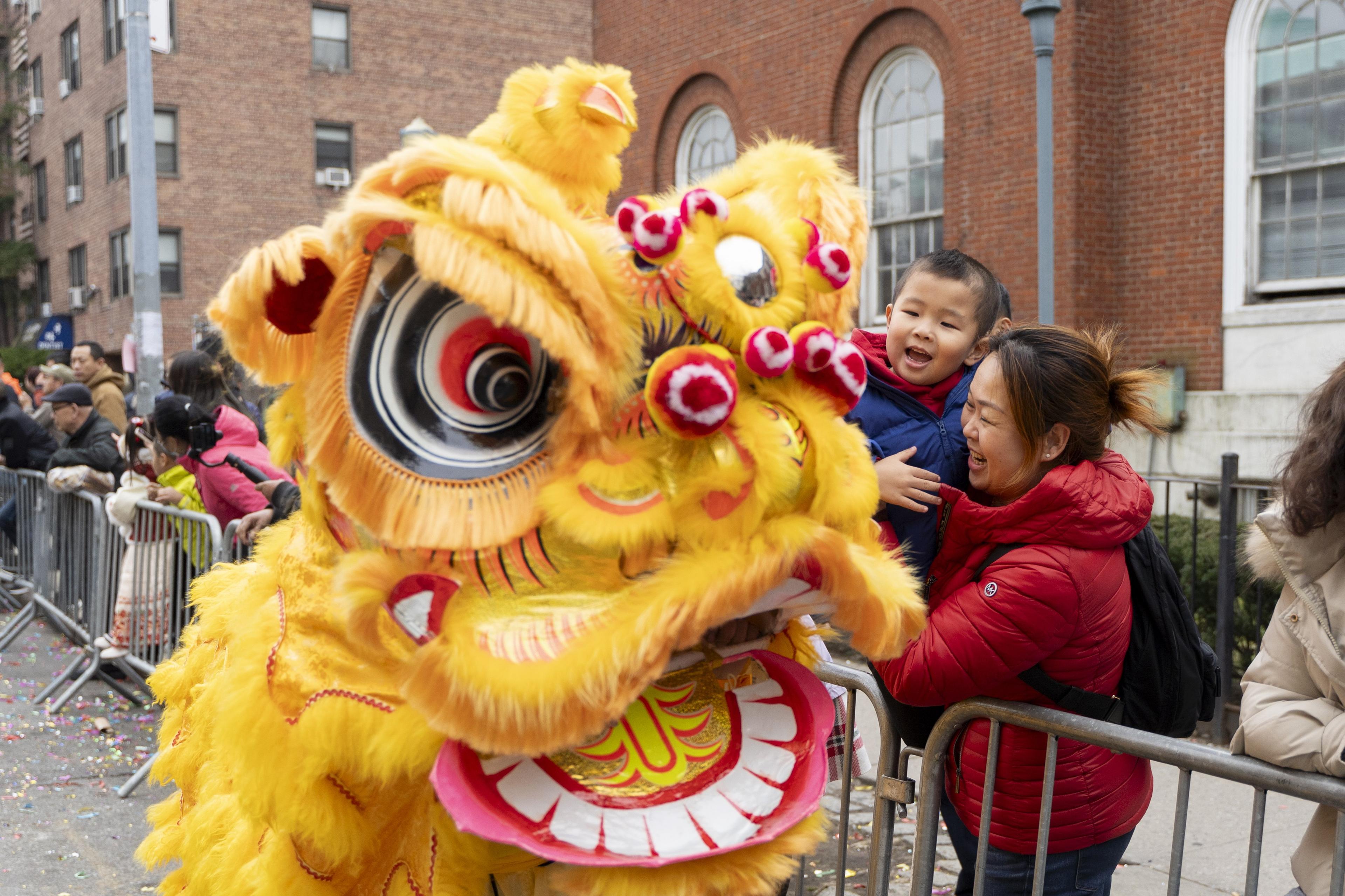 Falun Gong practitioners attend a parade celebrating the Chinese New Year, in the Flushing neighborhood of Queens, New York, on Feb. 10, 2024. (Chung I Ho/The Epoch Times)