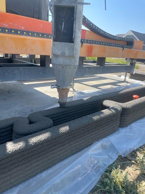 3D construction printer robot arm laying concrete mix in Muscatine, Iowa in mid-2023. (Courtesy of Ziyou Xu of RIC Technology)