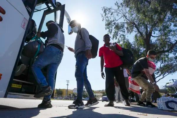 Illegal immigrants board a bus to the airport in San Diego on Oct. 6, 2023. (Gregory Bull/AP Photo)