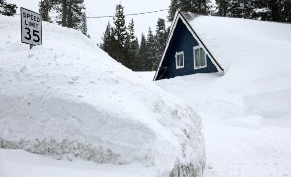 A home is partially covered in snow following a massive snowstorm in the Sierra Nevada mountains near Soda Springs, Calif., on March 4, 2024. (Mario Tama/Getty Images)