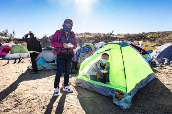 Chinese migrants settle at Willow Camp before being processed by Border Patrol agents in Jacumba, Calif., on Dec. 6, 2023. (John Fredricks/The Epoch Times)
