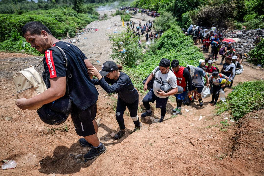 Migrants walk by the jungle near Bajo Chiquito village, the first border control of the Darien Province in Panama, on Sept. 22, 2023. (Luis Acosta/AFP via Getty Images)