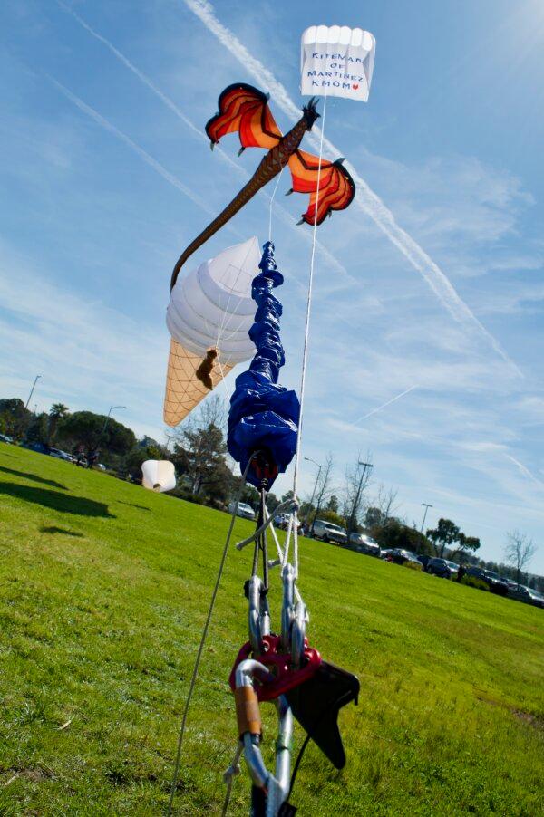 The “Kiteman of Martinez” kite and a dragon kite tethered to a stake at the marina in Martinez, Calif. (Keegan Billings/The Epoch Times)
