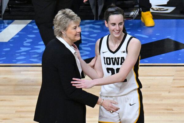 Iowa Coach Lisa Bluder and guard Caitlin Clark talk on the court after defeating LSU in an NCAA Tournament regional final in Albany, N.Y., on April 1, 2024. (Hans Pennink/AP Photo)